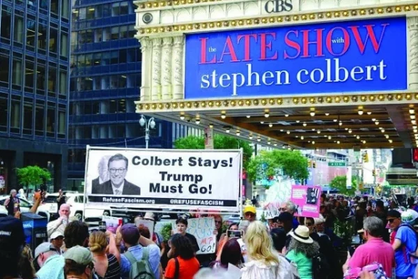 protesters hold placards supporting colbert photo afp