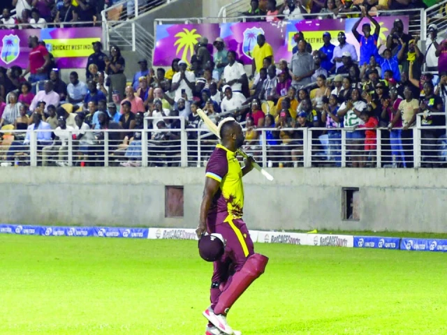 andre russell waves to fans at his home ground in kingston jamaica after batting for the final time in international cricket against australia on tuesday photo afp