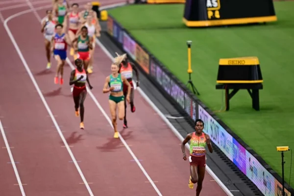 faith kipyegon competes the finish line to win the women s 1500m final during the world athletics championships in tokyo photo afp