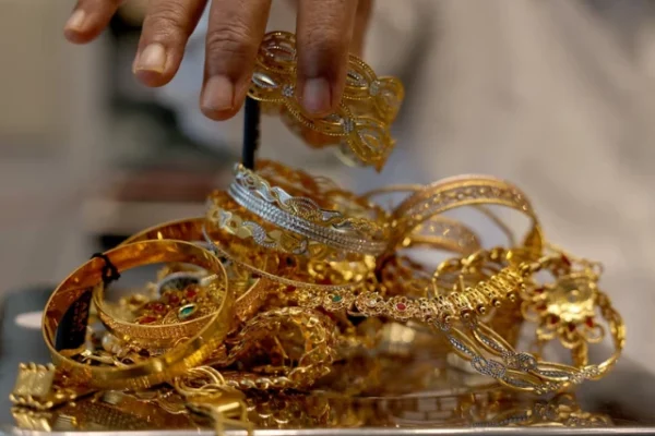 a goldsmith weighs gold jewellery inside a showroom photo reuters