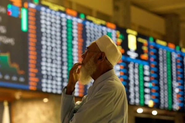 a stock broker reacts while monitoring the market on the electronic board displaying share prices during trading session at the pakistan stock exchange in karachi on july 3 2023 photo reuters file