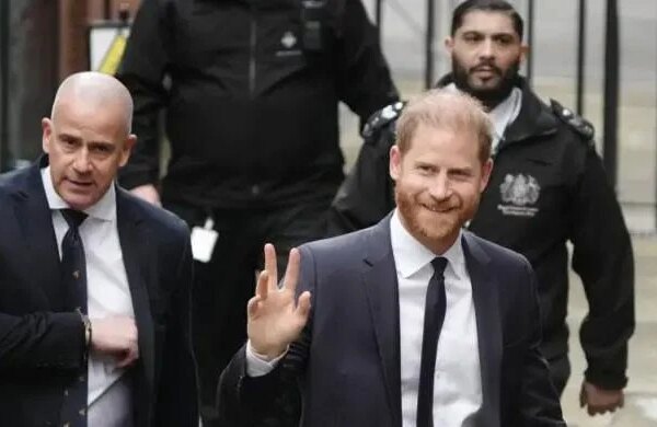 Prince Harry waves and receives good luck cheers on day two of trial