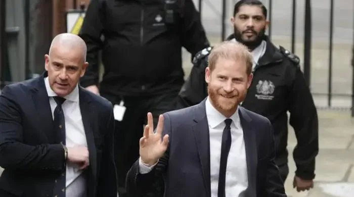 Prince Harry waves and receives good luck cheers on day two of trial