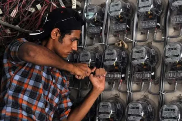 a technician from karachi electric pakistan s largest city s power supply company checks electricity meters at a residential building in karachi photo afp