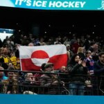 Olympic hockey fans raise Greenland's flag during USA's dominant win over Denmark, sparking viral reaction