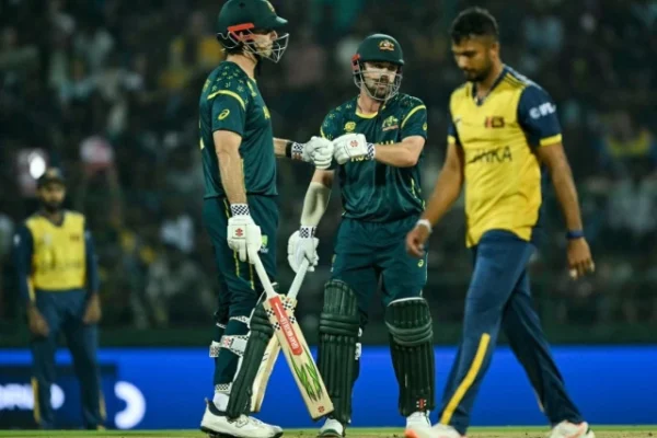 australia s captain mitchell marsh l and travis head c bump their fists during the 2026 icc men s t20 cricket world cup group stage match between australia and sri lanka at pallekele international cricket stadium in kandy on february 16 2026 photo afp
