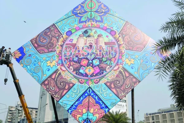 workers install a large kite model to celebrate the basant festival in lahore photo afp