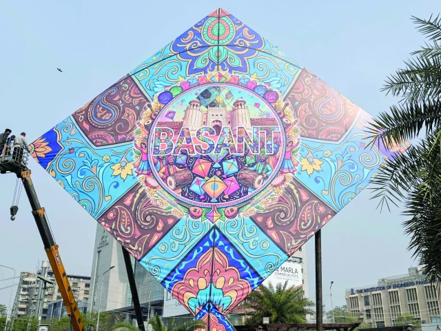 workers install a large kite model to celebrate the basant festival in lahore photo afp