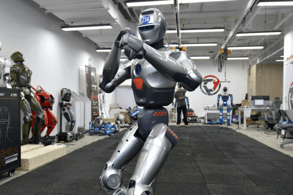 An EngineAI PM01 humanoid robot stands in a fighting stance.
