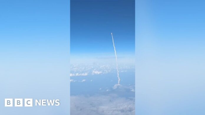 Passengers watch Artemis II blast off from commercial plane