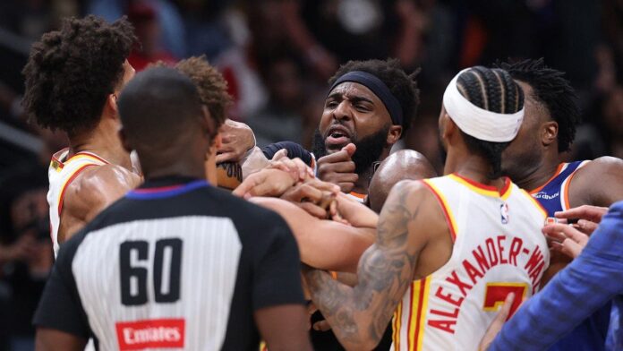 Two players ejected after scrum amid Knicks' 50-point lead against Hawks sends referee crashing to the court