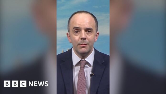 Health Secretary James Murray wearing suit and tie