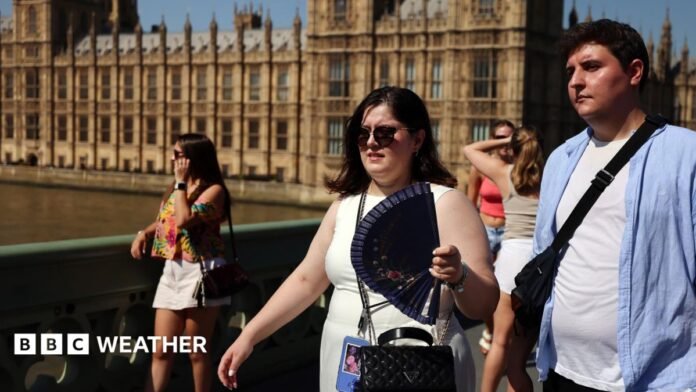 People looking hot in the sunshine with the Houses of Parliament in the background