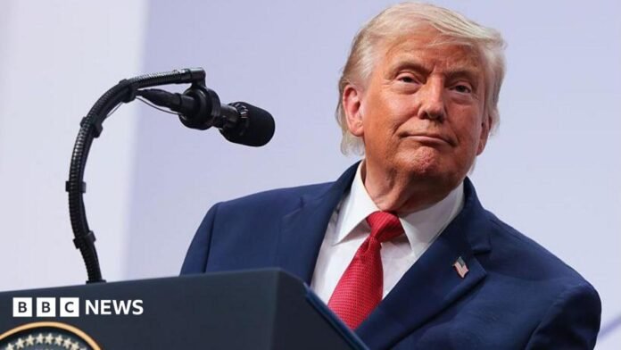 President Donald Trump speaking on stage during a press conference at the G7 Leaders' Summit 