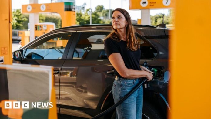 Woman filling up her car with petrol