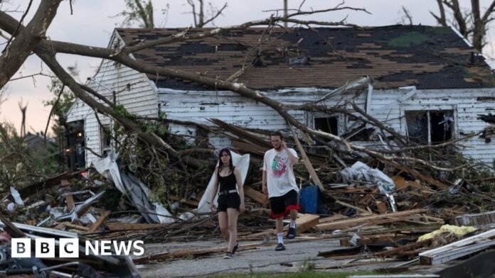 Residents survey damage after a tornado ripped through town.