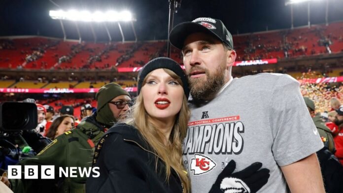 Taylor Swift and Travis Kelce in a sports stadium