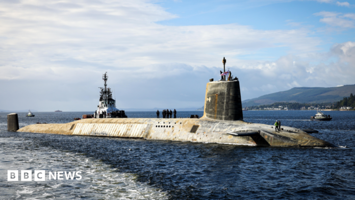 A shot of a Vanguard submarine half submerged in the water. 