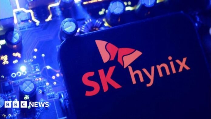 A screen displaying the SK Hynix logo posed above a computing motherboard