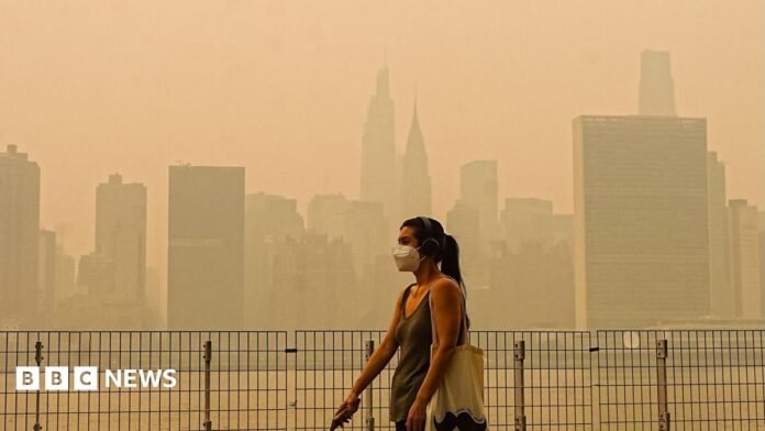 Smoke from massive wildfires in Canada engulfed the New York City skyline, reducing visibility and casting an orange haze over the New York City, United States on July 16, 2026. 