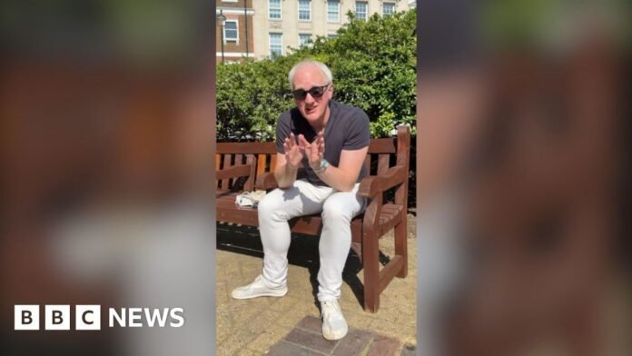James Gallagher in a park wearing sunglasses