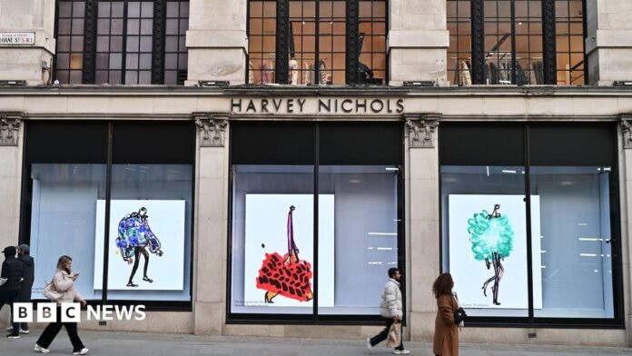 People walking past a luxury department store in Knightsbidge, London 