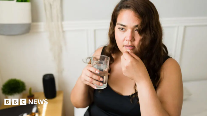 Woman taking pill
