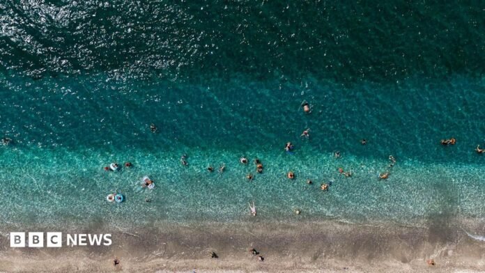 Aerial view of strip of beach in Greece and ocean